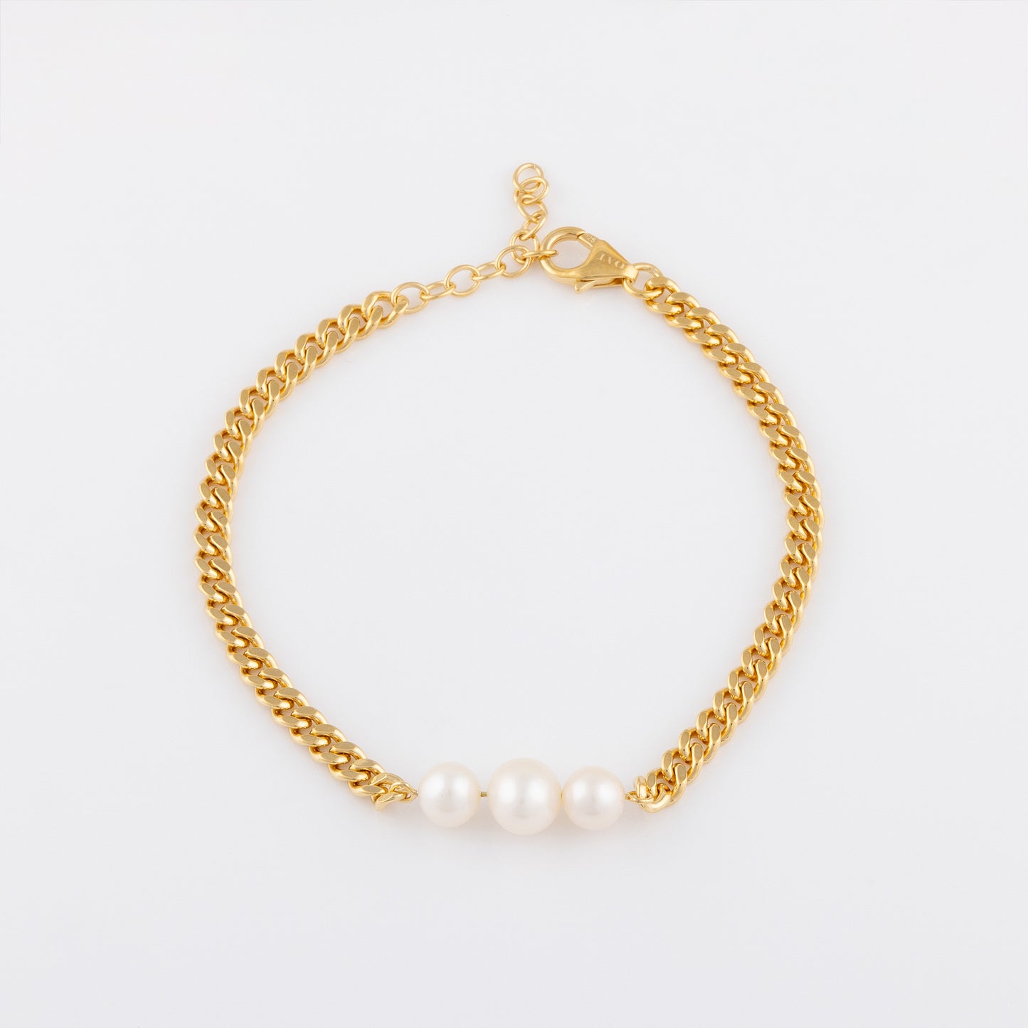 Overhead shpot of OAT's gold Vermeil Bracelet with Three Freshwater Pearls. The bracelet is aginst a plane white background and the pearls are reflecting light beautifully.