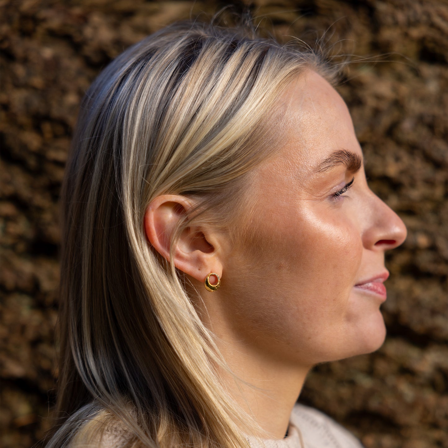 Side angle of model wearing OAT Jewellerys Gold Vermeil Circle Stud Earrings with White Cubic Zirconia. Nickle free and hypoallergenic earrings, suitable for sensitive ears