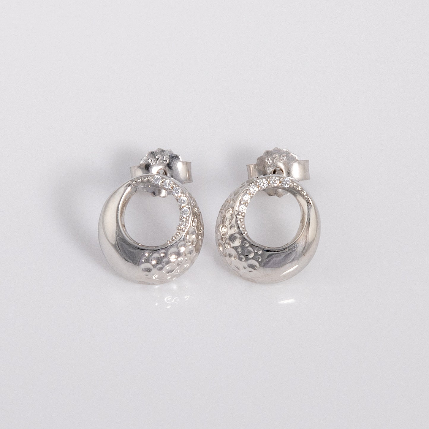Rhodium plated silver Circle Stud Earrings with White Cubic Zirconia and a textured finish. An elegant, dressy pair of earrings with a butterfly back. Suitable for sensitive ears, nickle free