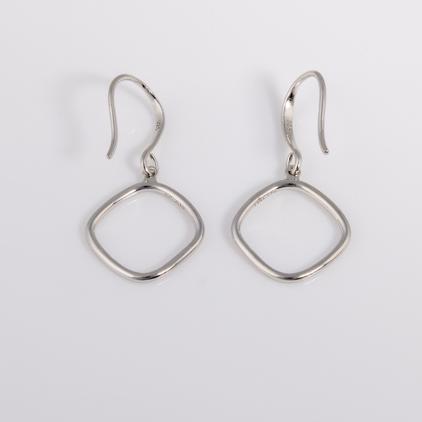 Simple Rhodium plated silver Hook Earrings that have a rounded edge, geometric shape. Tranish resistant and nickle free