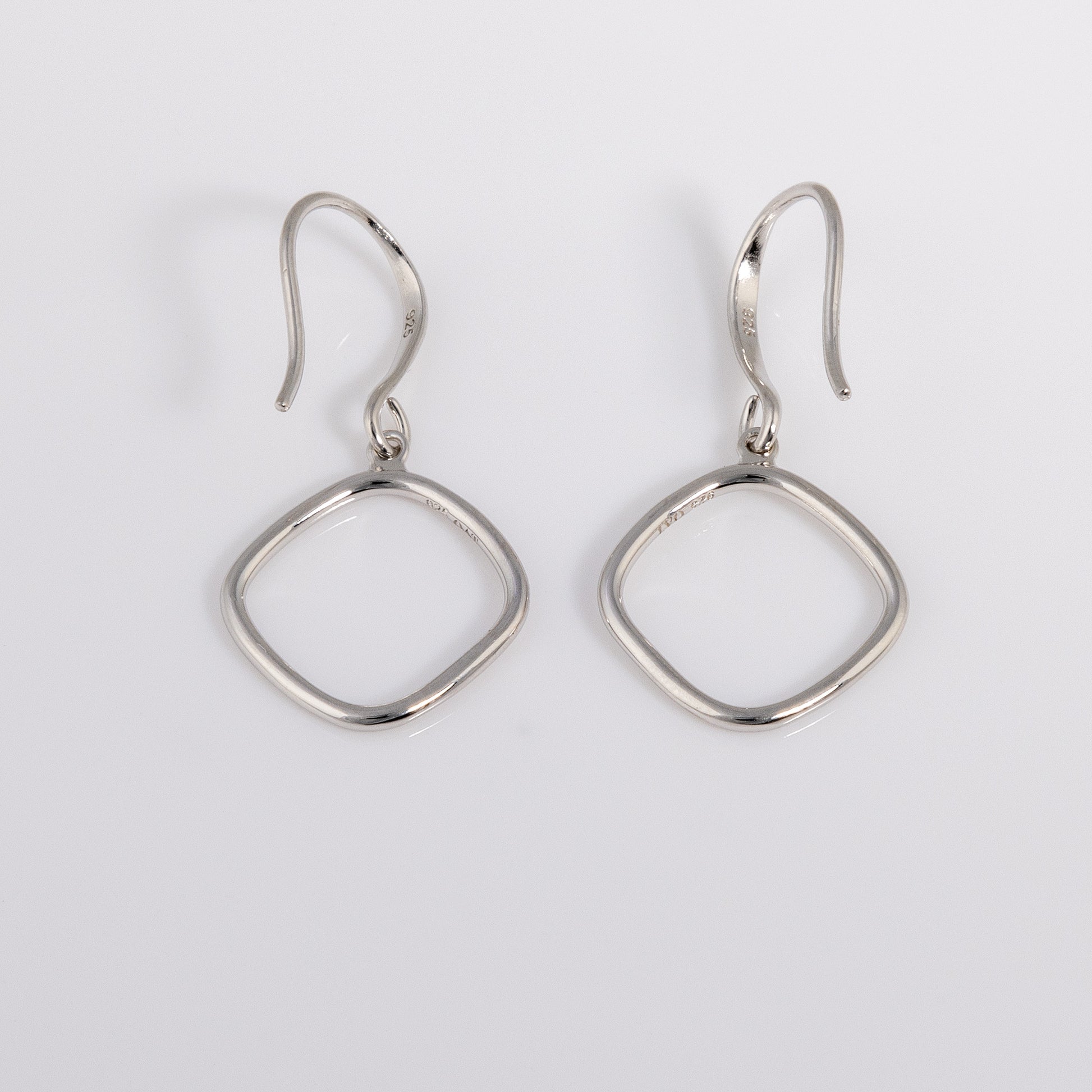 Simple Rhodium plated silver Hook Earrings that have a rounded edge, geometric shape. Tranish resistant and nickle free