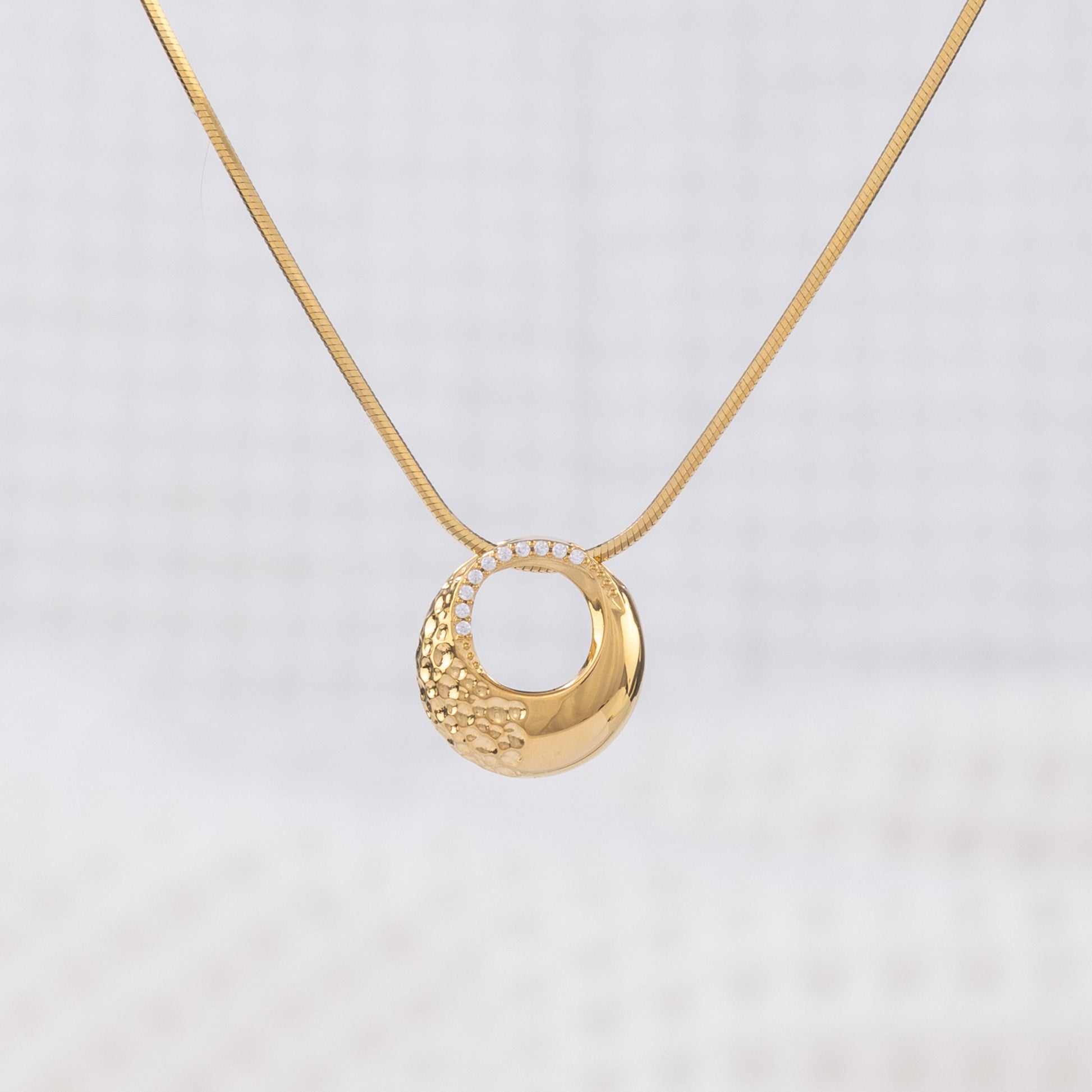 Classic gold Vermeil Circle Pendant Necklace with White Cubic Zirconia. The pendant hangs on a snake chain, giving a chic, elegant look. Tranish free and nickle free!