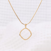 Simple Gold Vermeil Pendant Necklace. The pendant is a geometric shape with rounded edges.