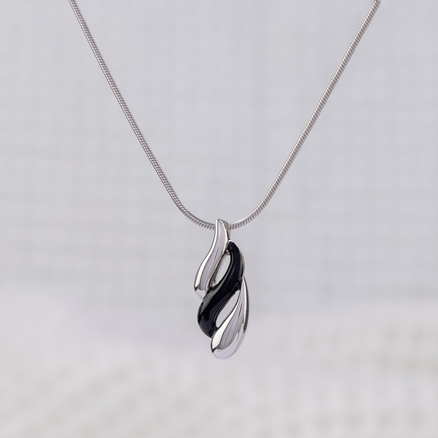 Silver Rhodium and Black Enamel Pendant Necklace with Wave Design