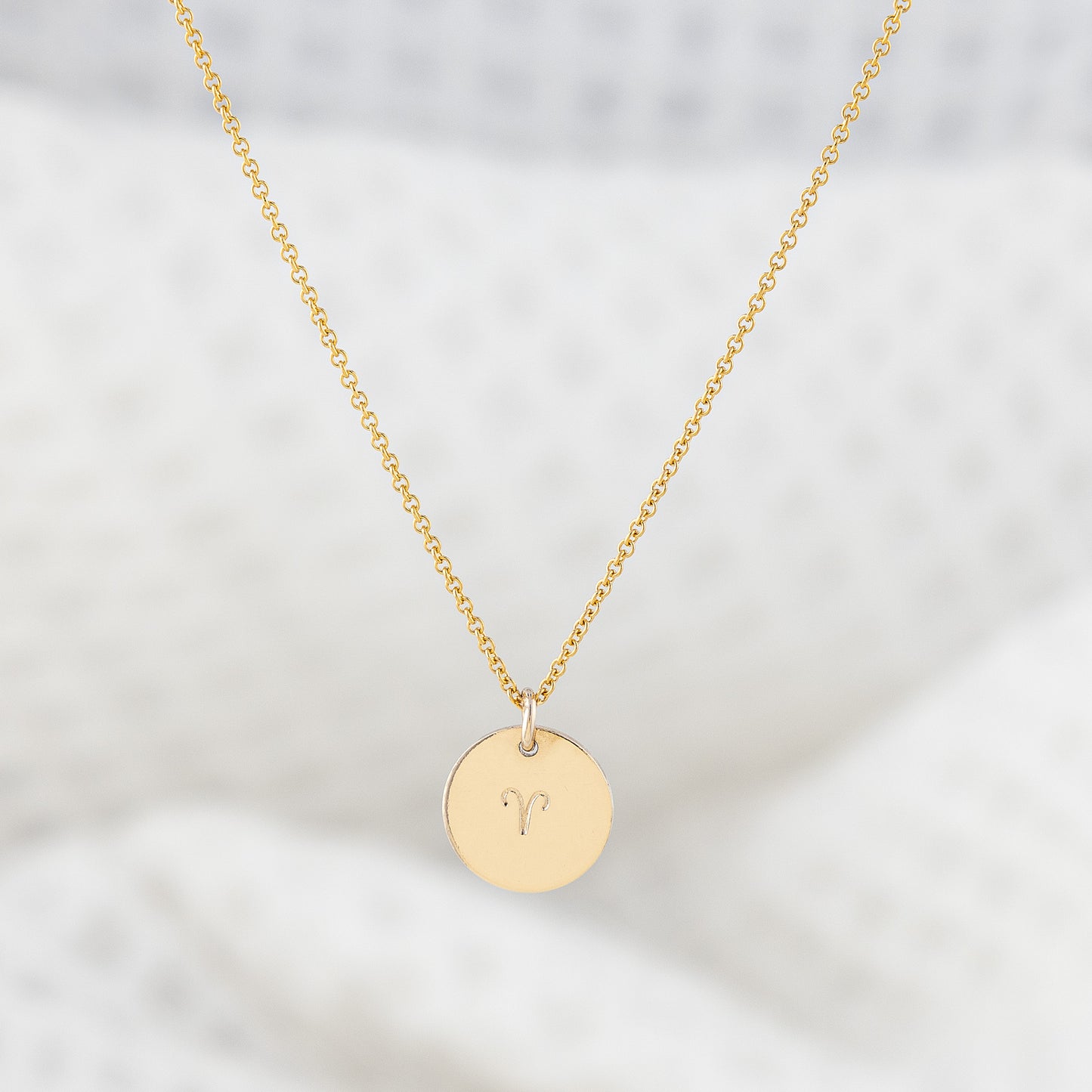 A 14ct gold filled necklace with a disc pendant hand stamped with a star sign. The smooth finish disc hangs on a fine gold chain. Tarnish free and nickle free.