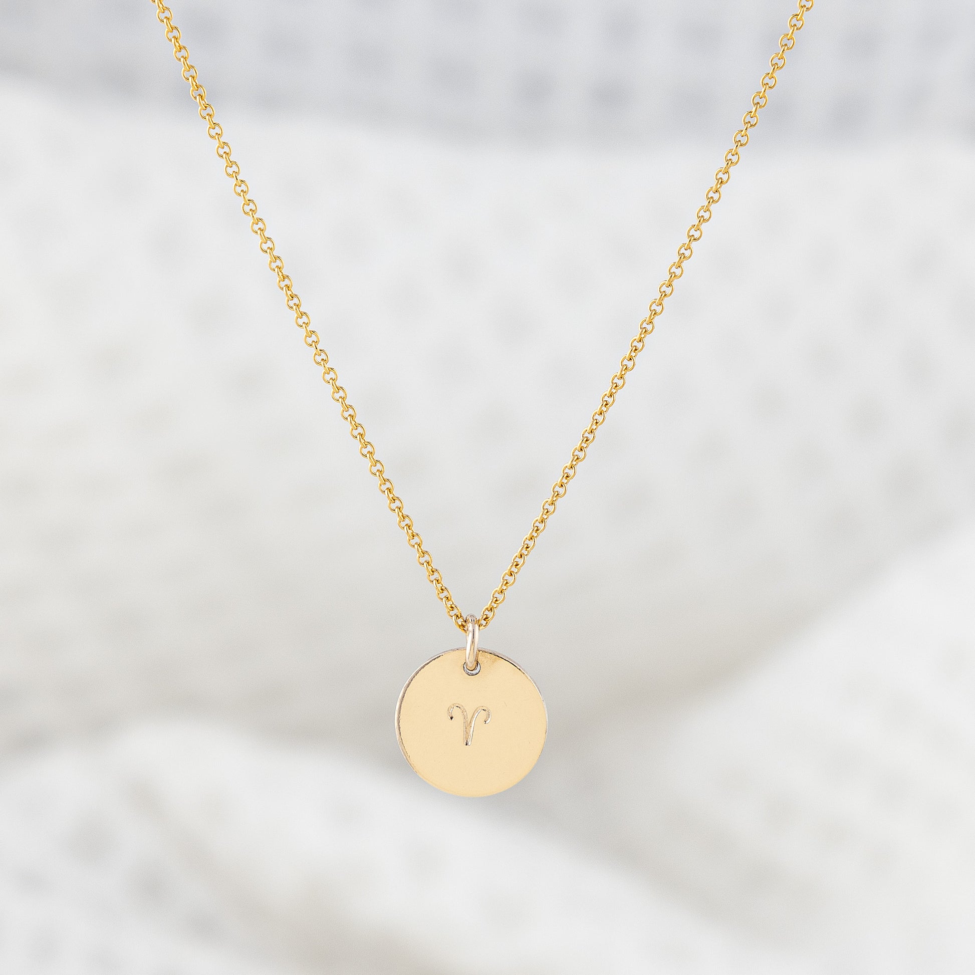 A 14ct gold filled necklace with a disc pendant hand stamped with a star sign. The smooth finish disc hangs on a fine gold chain. Tarnish free and nickle free.