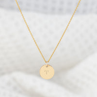 A 14ct gold filled necklace with a disc pendant hand stamped with a star sign. The smooth finish disc hangs on a fine gold chain. Tarnish free and nickle free.