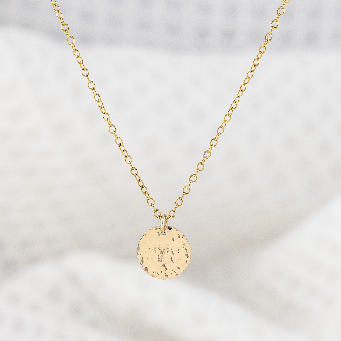 14ct gold filled pendant necklace, personalised with astrology sign. The disc pendant is a hammered texture and hand is stamped with a star sign. The chain is delicate and adjustable in lenght. Trnish resistant and hypoallergenic.