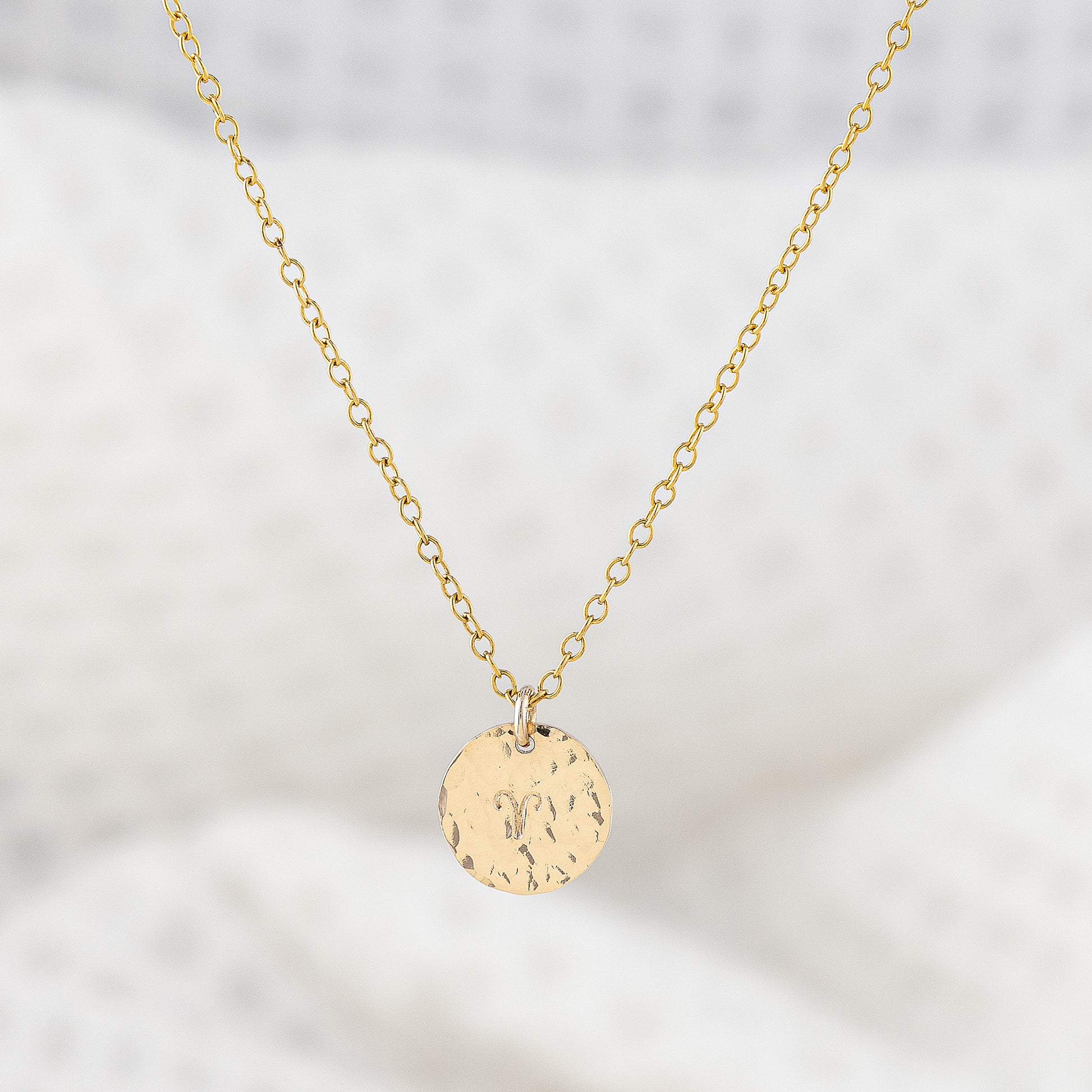 14ct gold filled pendant necklace, personalised with astrology sign. The disc pendant is a hammered texture and hand is stamped with a star sign. The chain is delicate and adjustable in lenght. Trnish resistant and hypoallergenic.