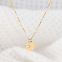 Personalsied star sign pendant necklace. OAT Jewellery's 14ct gold filled disc pendant. The disc is  a hammered finish with a zodiac sign stamped in the center.
