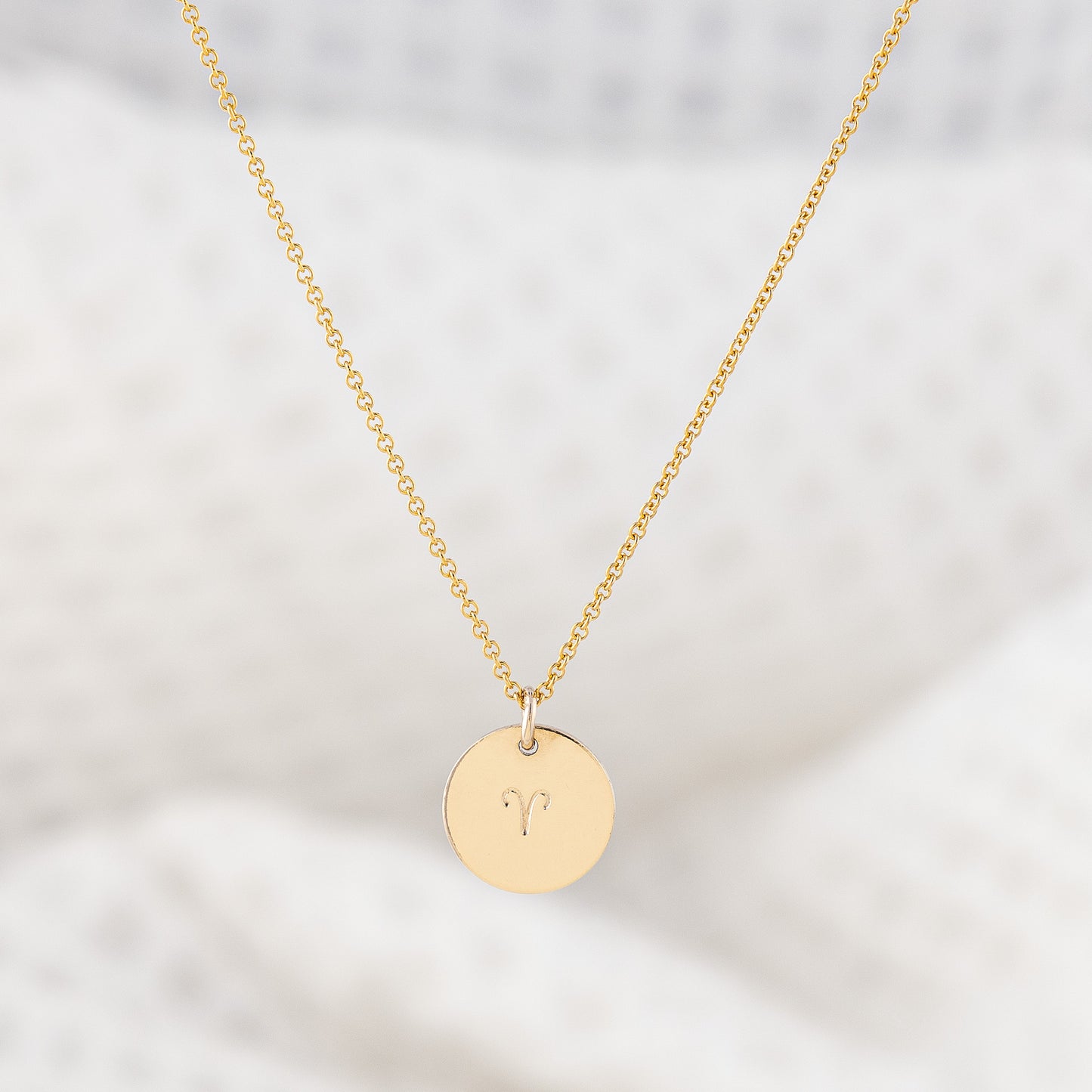 14ct gold filled disc necklace. The disc pendant is a smooth finish, stamped with a zodiac sign. The star sign pendant hangs on a delicate, fine chain that is adjustable in lenght