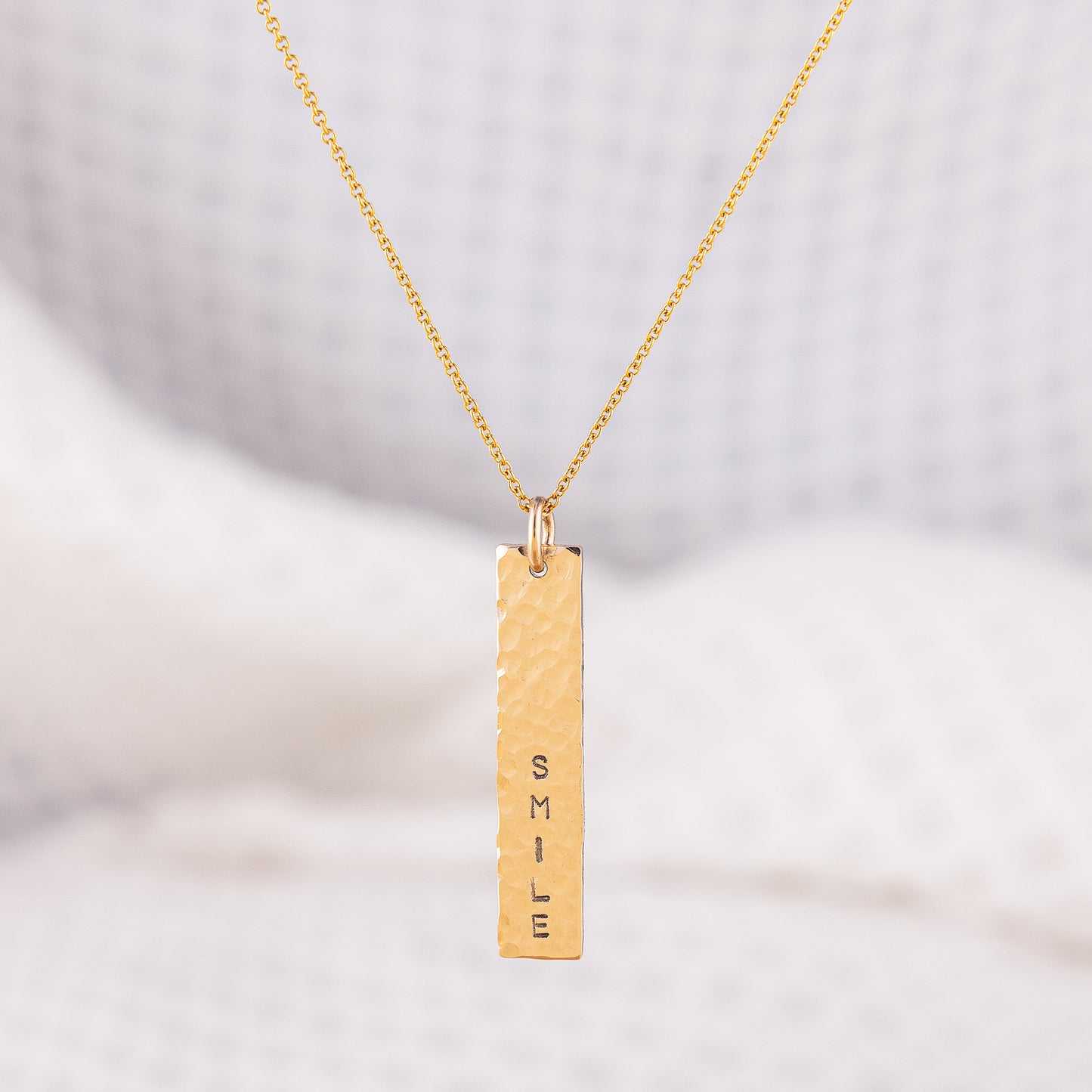 Custom word, hammered bar pendant necklace. The pendant is a verticle, tectured, sparkly, 14ct gold-fill bar that is stamped with a custom word of your choice. This personalised pendant is hand crafted and hangs upon a fine 16 inch adjustable lenght chain.