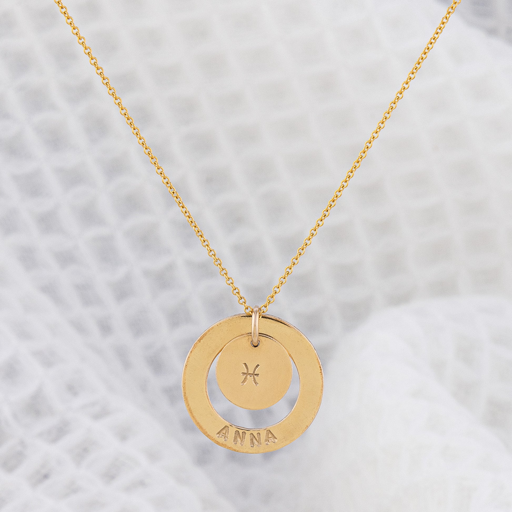 Zodiac necklace! The Doey necklace from OAT Jewellert is hand made in Ireland and personalised with your name and star sign. The necklace is made of tarnish free and hypoallergenic 14ct gold-fill. The pendant has a halo stamped with your name and a small disc in the centre of the halo, stamped with your star sign. A best seller!