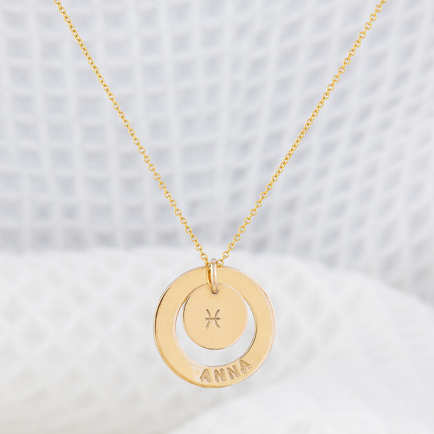 Astrology necklace, personalised with your name. The necklace is a stunning 14ct gold-filled finish, the pendant being a smooth halo with your name stamped into the gold. There is a small disc inside the halo with your star sign embossed in the centre. The chain is delicate and fine. Perfect for everyday wear, hypoallergenic and tarnish free!