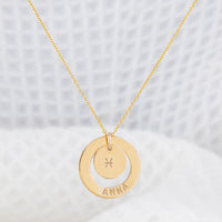 Astrology necklace, personalised with your name. The necklace is a stunning 14ct gold-filled finish, the pendant being a smooth halo with your name stamped into the gold. There is a small disc inside the halo with your star sign embossed in the centre. The chain is delicate and fine. Perfect for everyday wear, hypoallergenic and tarnish free!