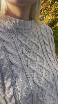 video of OAT Jewellerys Simple Rhodium plated silver Pendant Necklace. The pendant is a rounded geometric shape and hangs upon a snake chain.