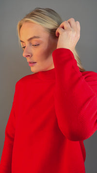 Video showing model wearing gold Vermeil Circle Stud Earrings with White Cubic Zirconia. Paired beautifully with a red shirt