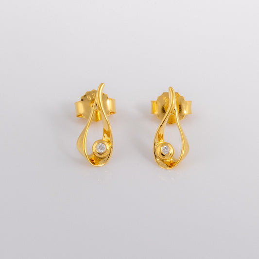 Gold vermeil stud earrings that have a teardrop design with a set diamond detail. the earrings have a butterfly clasp and are photographed on a white background