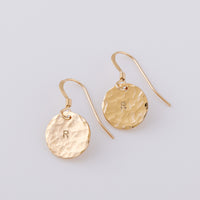 two fish hook, disc earrings. The disc is 14ct gold-fill and a hammered finish, giving them a beautiful sparkle. The earrings are stamped with an initial