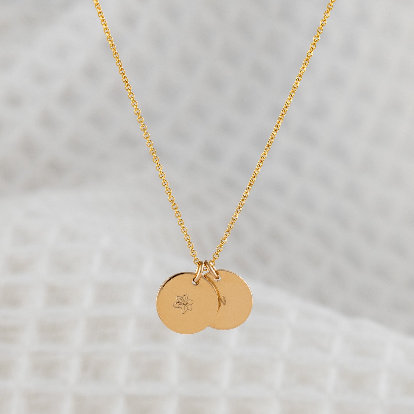 14ct gold filled personalised disc, pendant necklace. OAT jewellerys Malin Beag necklace features two smooth finish discs, personalised with a birthflower stamped on one and an initial stamped on the other. They hang upon a fine, adjustable lenght chain. 