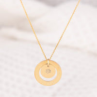 OAT Jewellerys grgeous Dooey personalised necklace. The 14ct gold-fill necklace has a halo pendant, stamped with a birth month with a pendant inside stamped with the matching birthflower. A dainty everyday necklace, hypoallergenic and a beautiful gift for a new Mom!