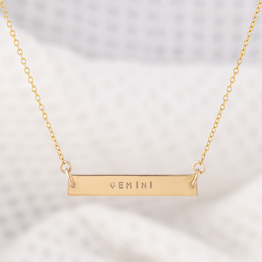 14ct Gold-filled gold name bar necklace. A smooth gold bar stamped with a star sign attached to a fine chain